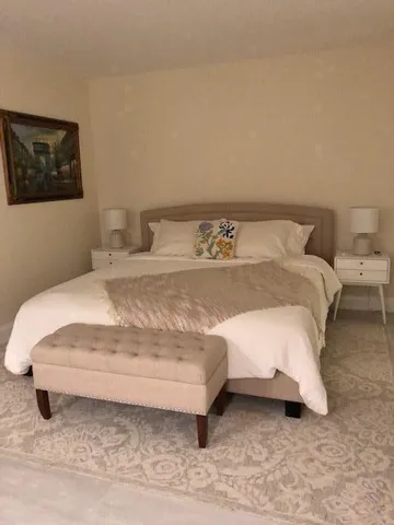 a large white bed sitting in a bedroom