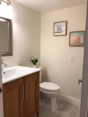 a bathroom with a sink mirror vanity and a toilet