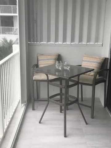 a view of a chairs and table in a balcony