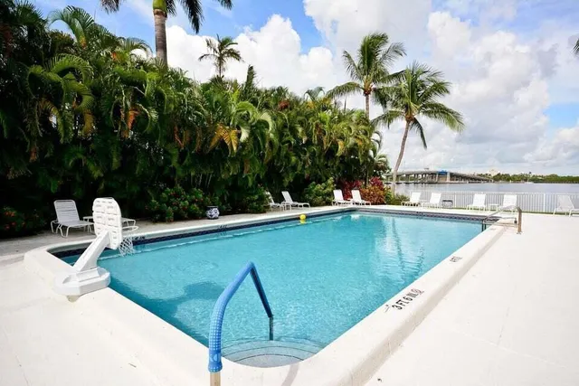 a view of a swimming pool with a patio and a garden