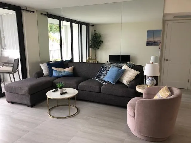 a living room with furniture and a large window