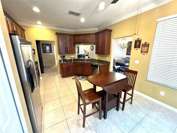 a dining room with furniture a window and kitchen view