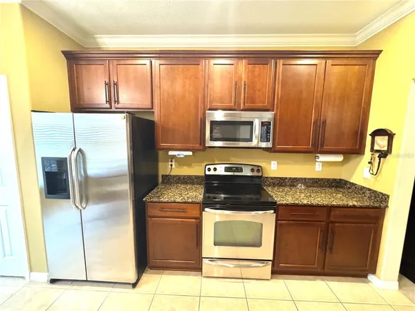 a kitchen with a sink stove and cabinets