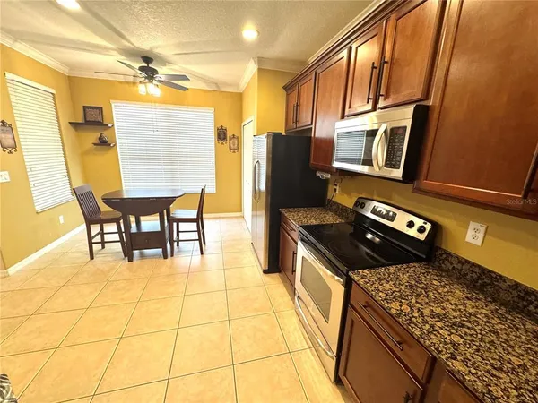 a kitchen with stainless steel appliances granite countertop sink stove and granite counter top
