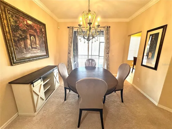 a dining room with furniture and wooden floor