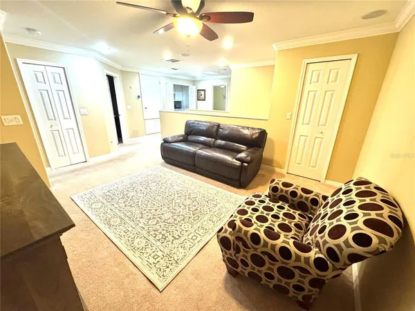 a bedroom with a bed and a ceiling fan