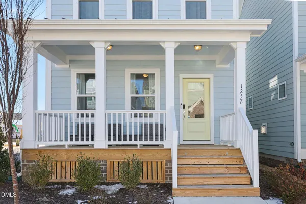 a view of a house with a small deck
