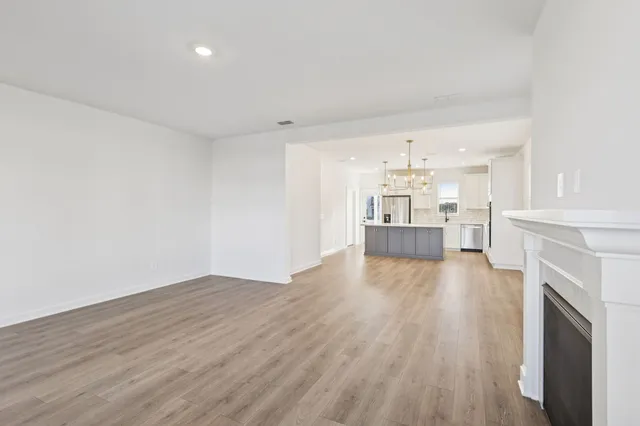 a view of a kitchen with wooden floor and a kitchen
