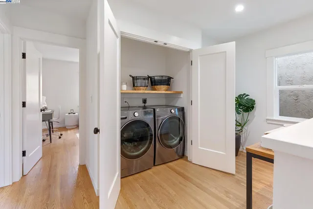 a view of a hallway with washer and dryer