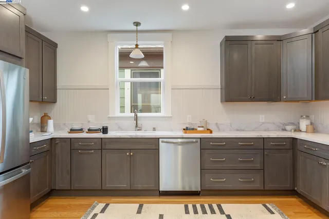 a kitchen with a sink window and cabinets
