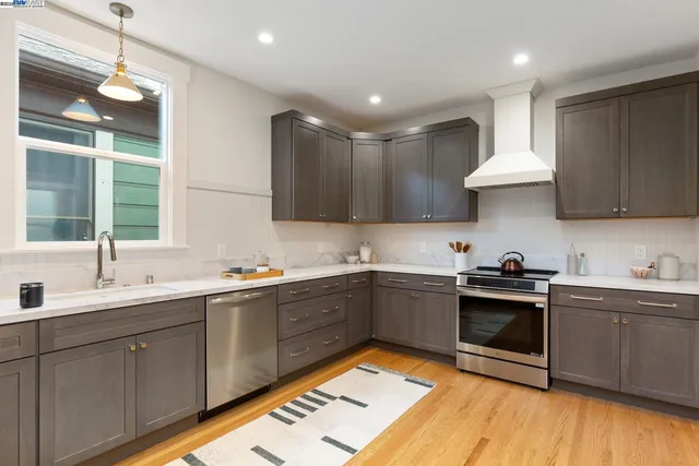a kitchen with a sink cabinets and stainless steel appliances