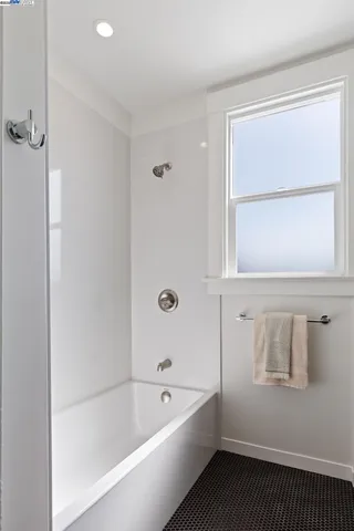 a bathroom with a bathtub and a window