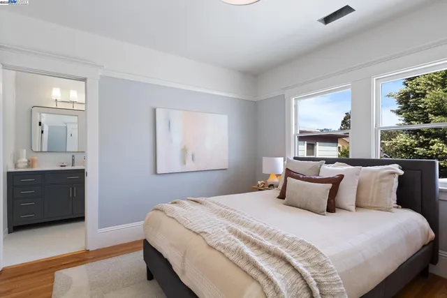 a bedroom with a large bed and a window