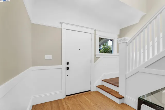 a view of small space with wooden floor and white walls