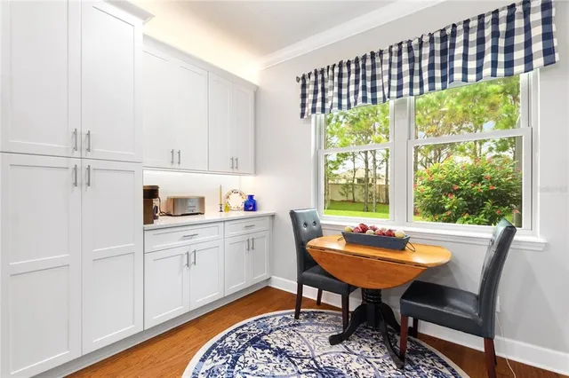 a living room with furniture a flat screen tv and a floor to ceiling window