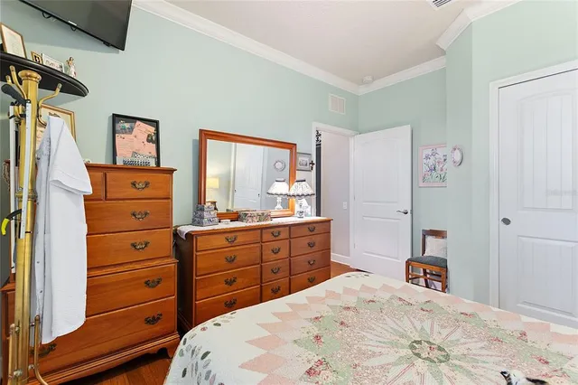 a view of a bedroom with furniture and wooden floor