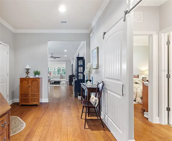 a view of a house with a big yard plants and large trees