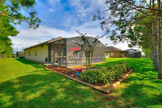 an aerial view of a house with a swimming pool outdoor seating and yard