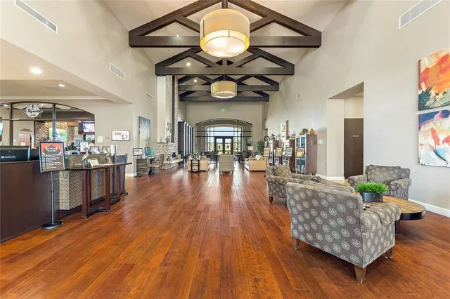 a room with lots of wooden furniture and stainless steel appliances