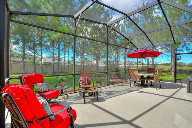 an outdoor sitting area with furniture and garden view