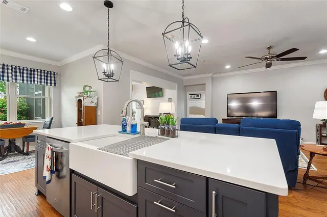 a kitchen with a refrigerator a sink and cabinets