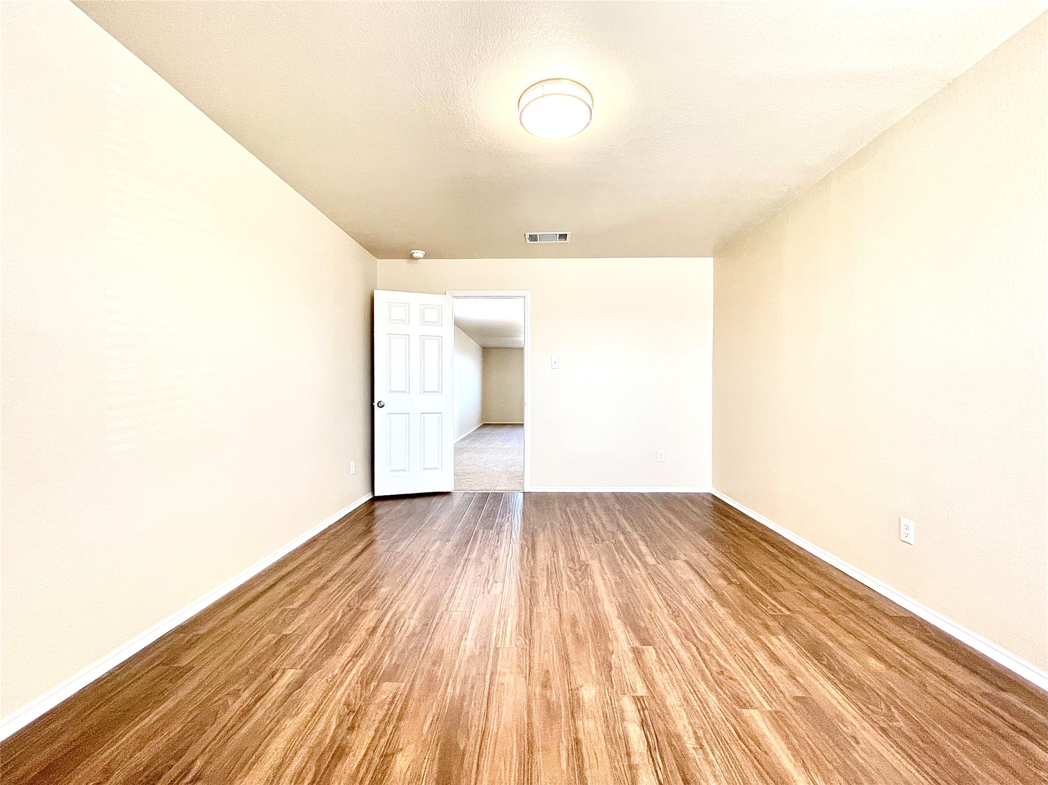 508 Emma Rose Trail Leander, TX 78641 - Photo 19 of 40 Rich hardwood-style flooring extends across this versatile interior space, perfect for any living arrangement.