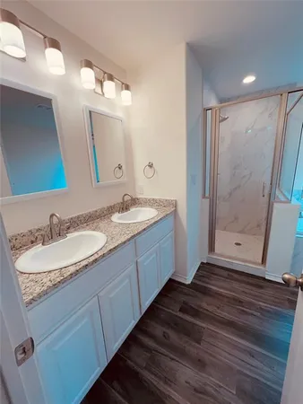 a bathroom with a double vanity sink and mirror