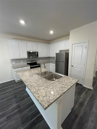 a view of kitchen with cabinets and wooden floor