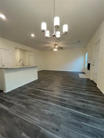 a view of a room with wooden floor and staircase