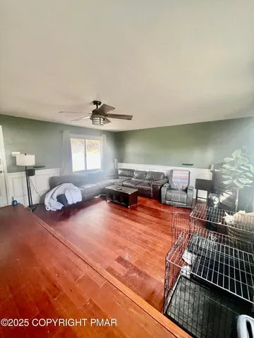 a view of a livingroom with furniture and a ceiling fan