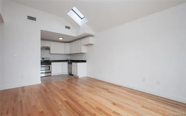 a kitchen with granite countertop white cabinets and white appliances