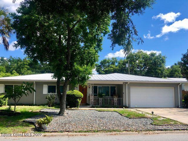 111 Highview Drive Cocoa, FL 32922 - Photo 1 of 17 a front view of a house with garden and parking