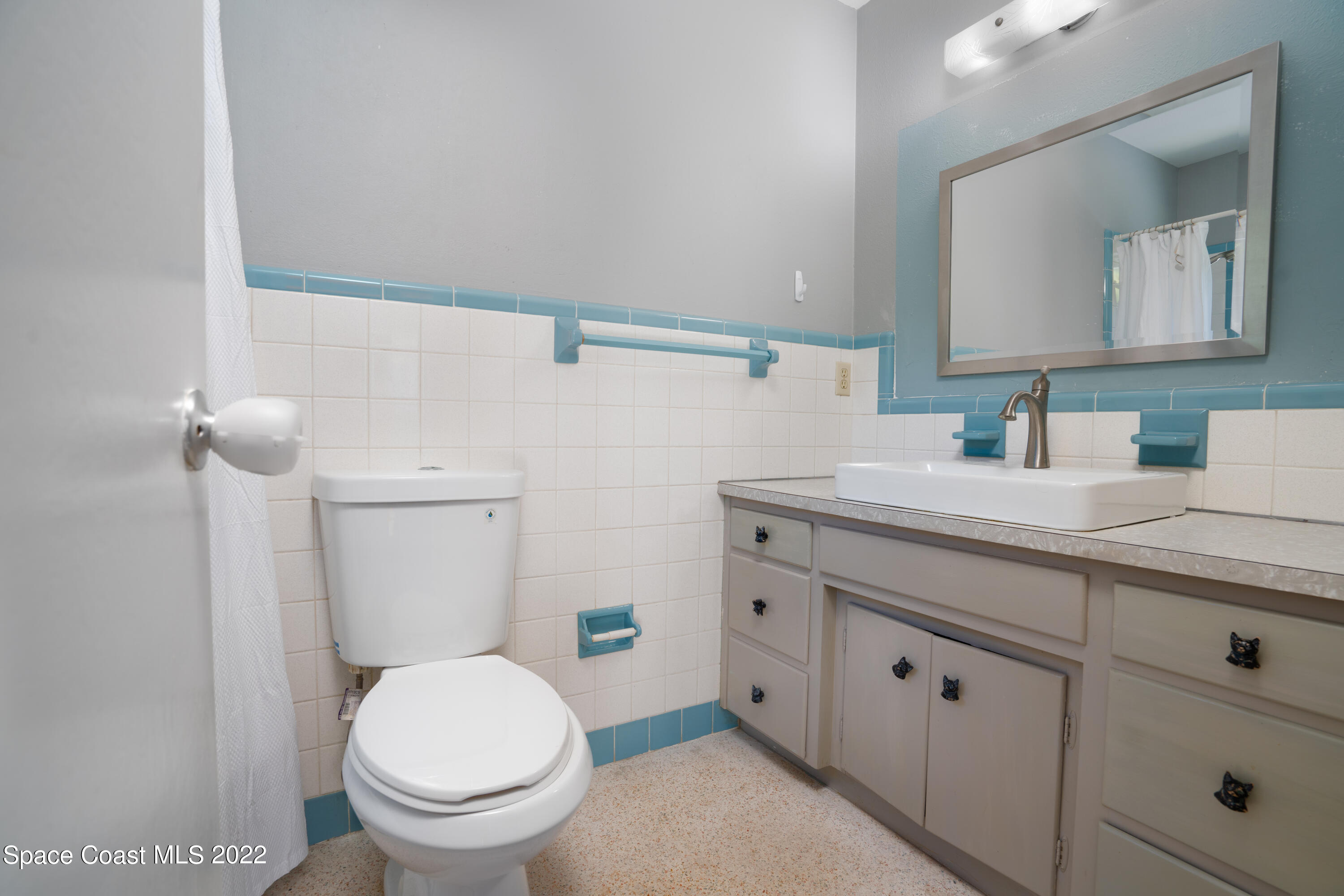 111 Highview Drive Cocoa, FL 32922 - Photo 11 of 17 a bathroom with a granite countertop toilet sink and mirror