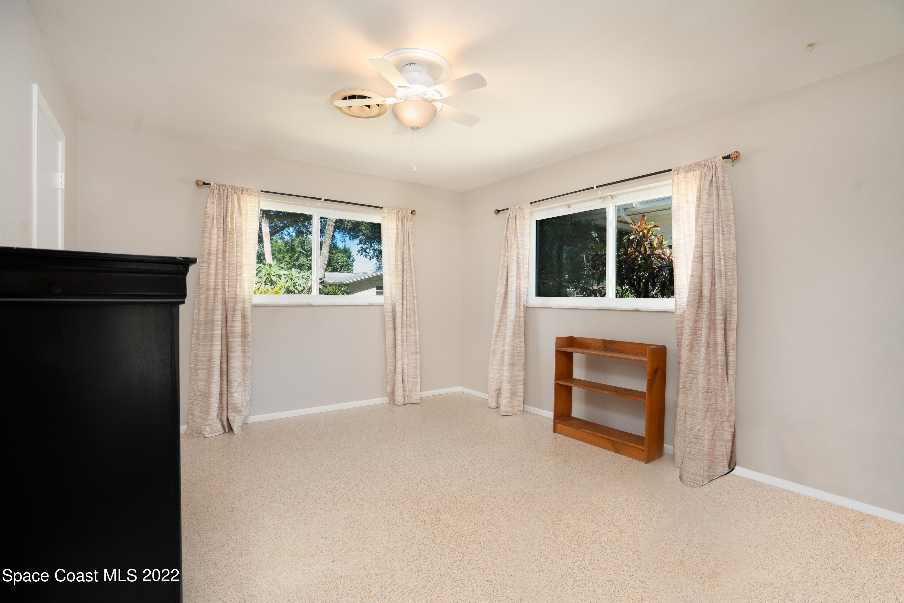 111 Highview Drive Cocoa, FL 32922 - Photo 13 of 17 a view of empty room with a fireplace and fan