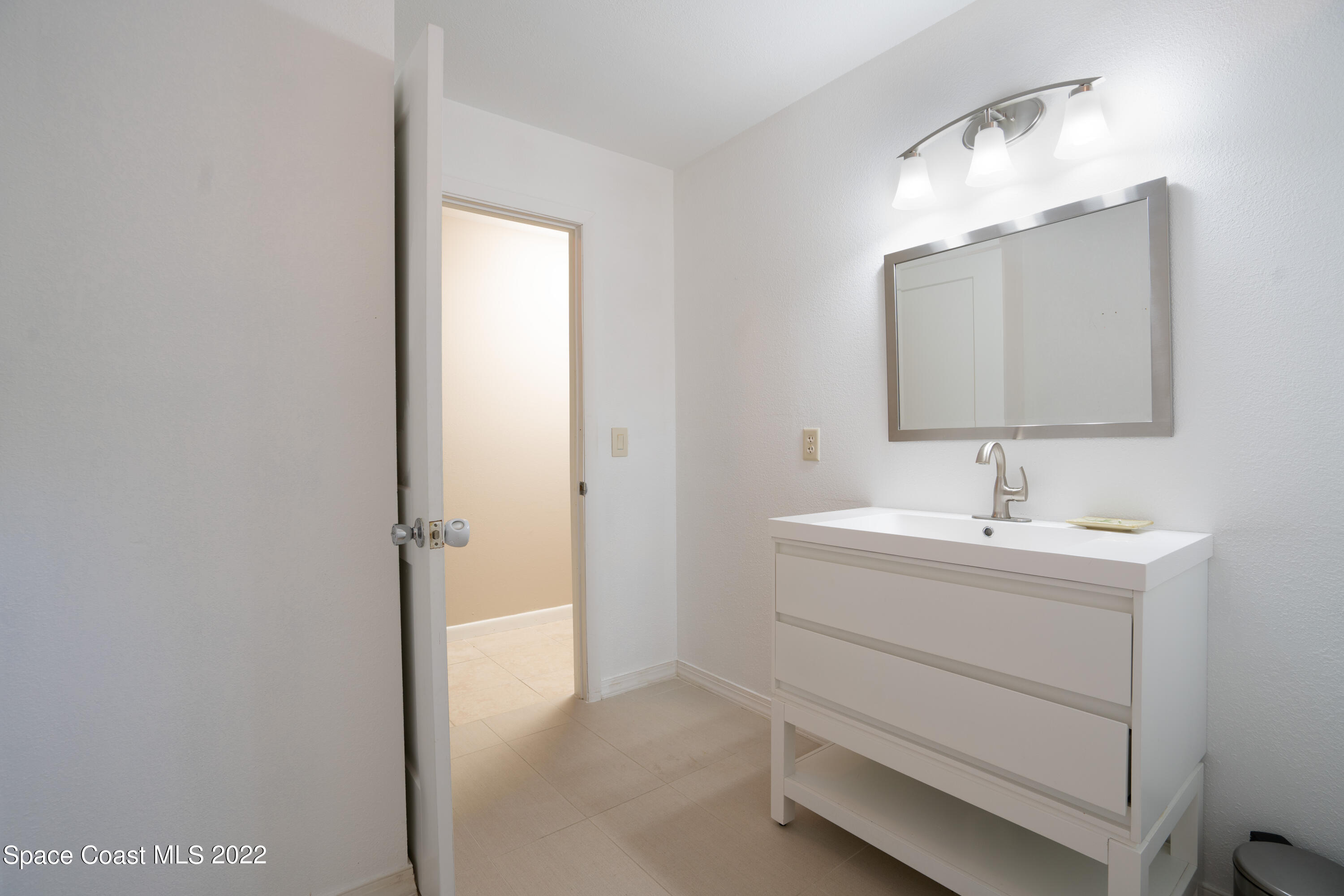 111 Highview Drive Cocoa, FL 32922 - Photo 15 of 17 a bathroom with a sink and a mirror