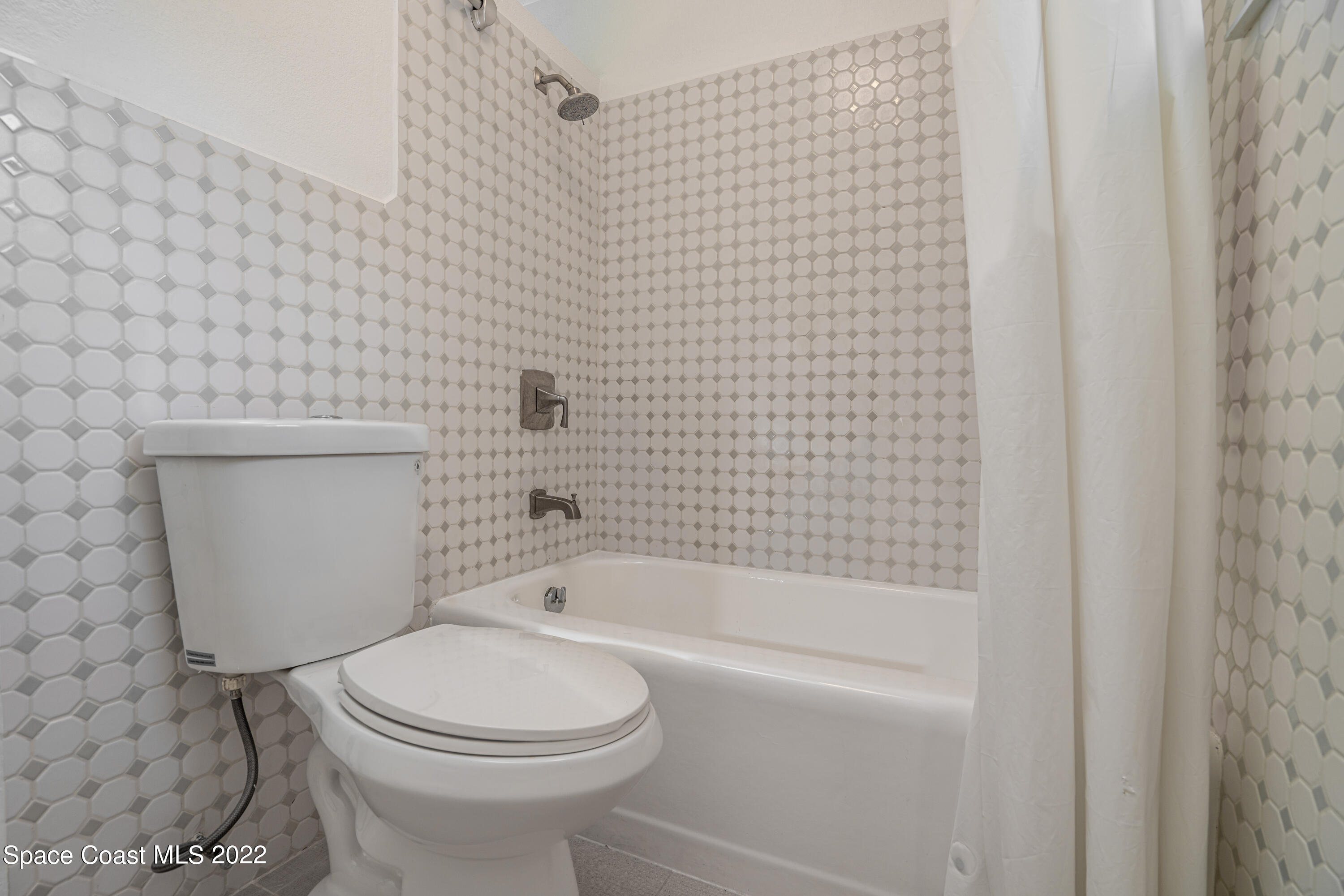 111 Highview Drive Cocoa, FL 32922 - Photo 16 of 17 a bathroom with a toilet and a bathtub