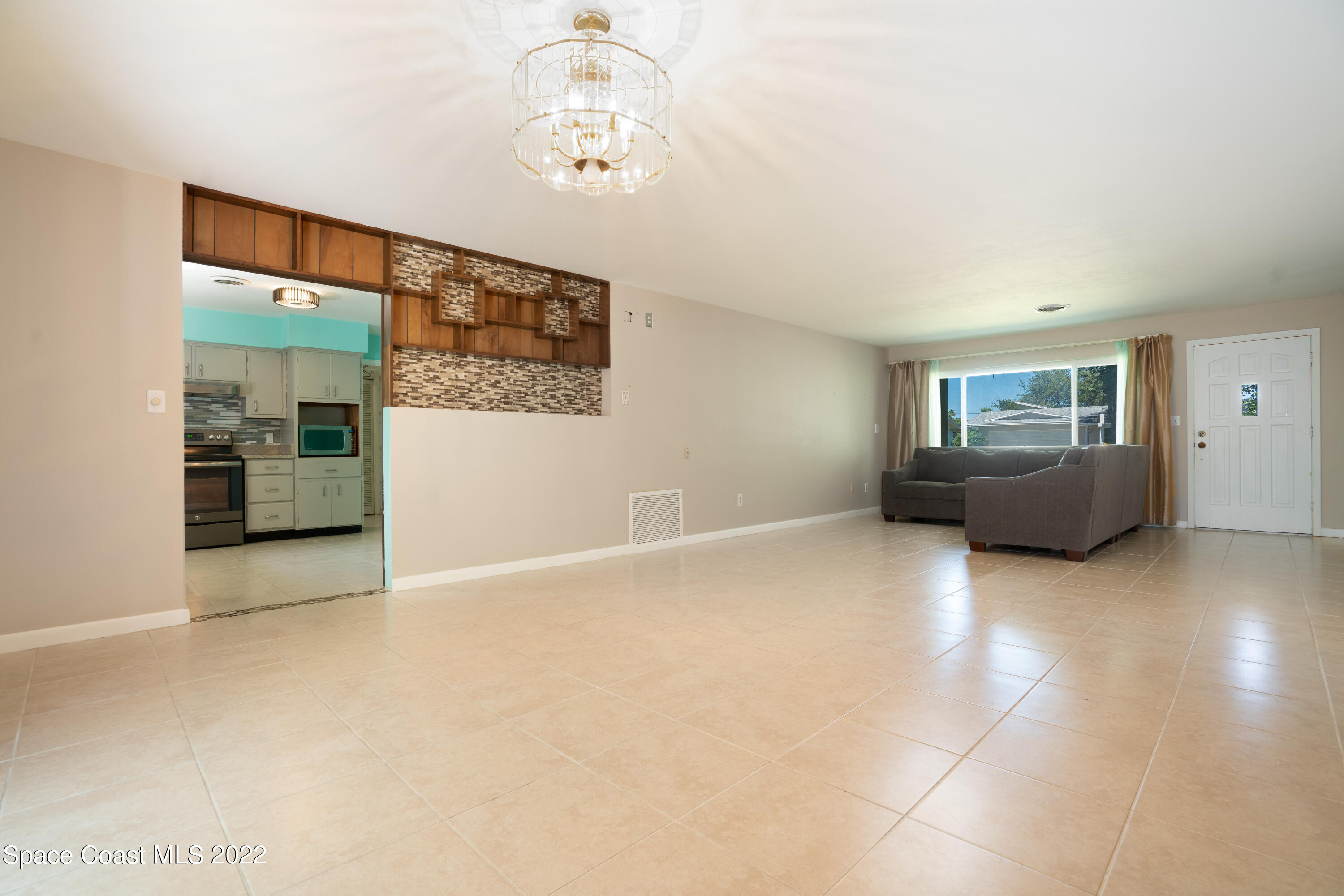 111 Highview Drive Cocoa, FL 32922 - Photo 7 of 17 an empty room with windows and furniture