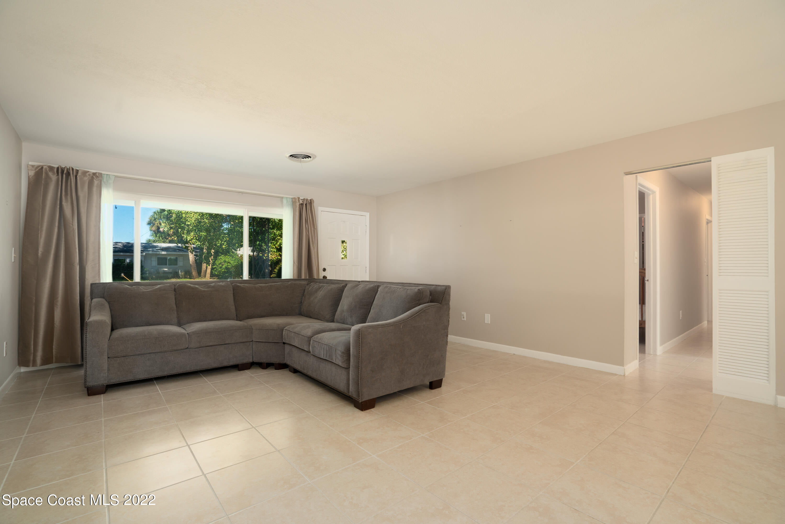 111 Highview Drive Cocoa, FL 32922 - Photo 8 of 17 a living room with furniture and a window