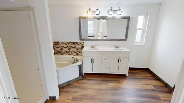a bathroom with a sink a mirror and a shower
