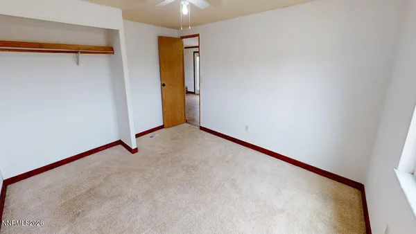a view of a small space with wooden floor and a window