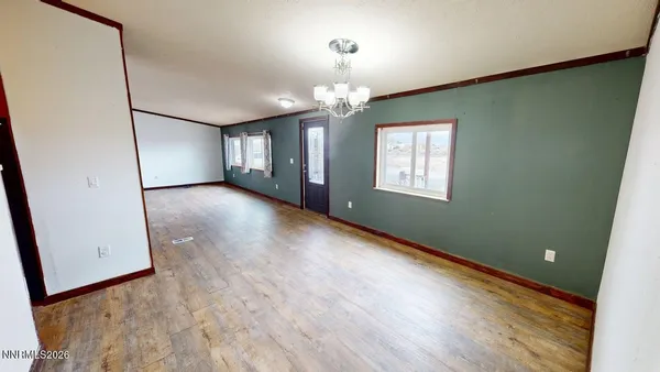 a view of a livingroom with wooden floor and stairs