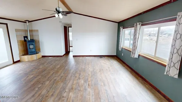 a view of a kitchen with furniture and wooden floor