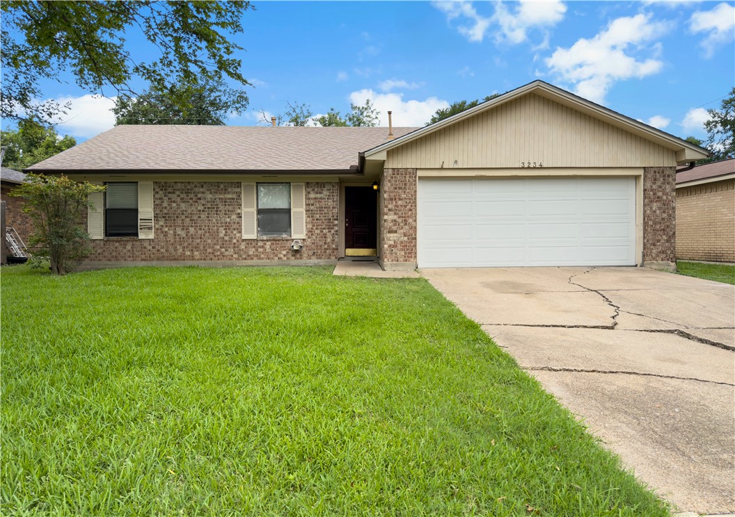 3234 Red Robin Loop Bryan, TX 77802 - Photo 2 of 19 a front view of a house with a yard and garage