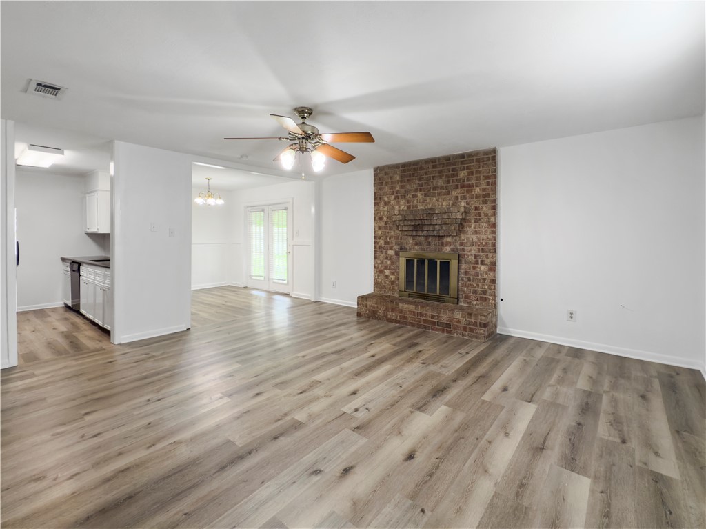 3234 Red Robin Loop Bryan, TX 77802 - Photo 5 of 19 a view of empty room with wooden floor and fireplace