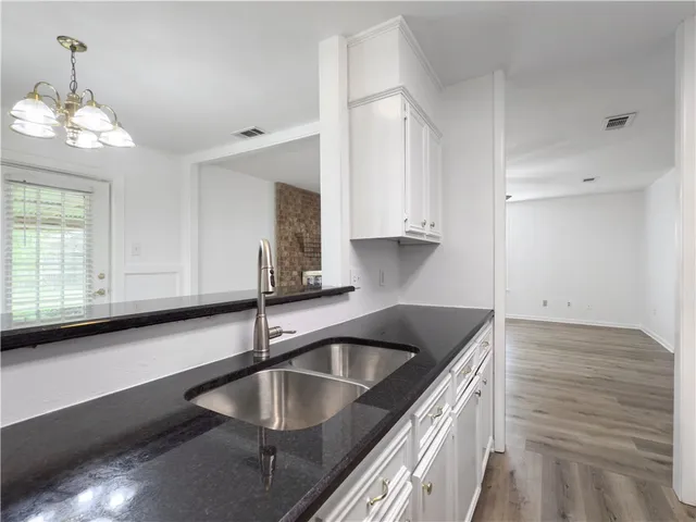 a kitchen that has a sink and a stove