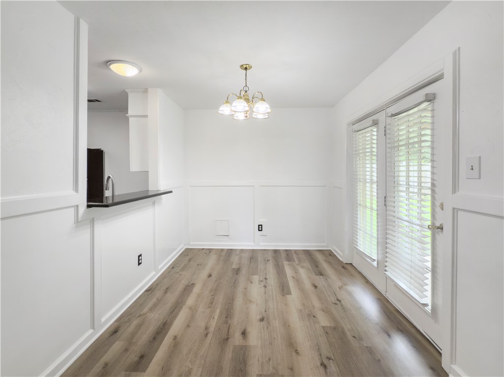 3234 Red Robin Loop Bryan, TX 77802 - Photo 9 of 19 wooden floor in an empty room with a window