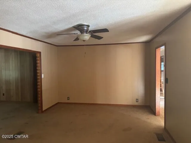 an empty room with a ceiling fan