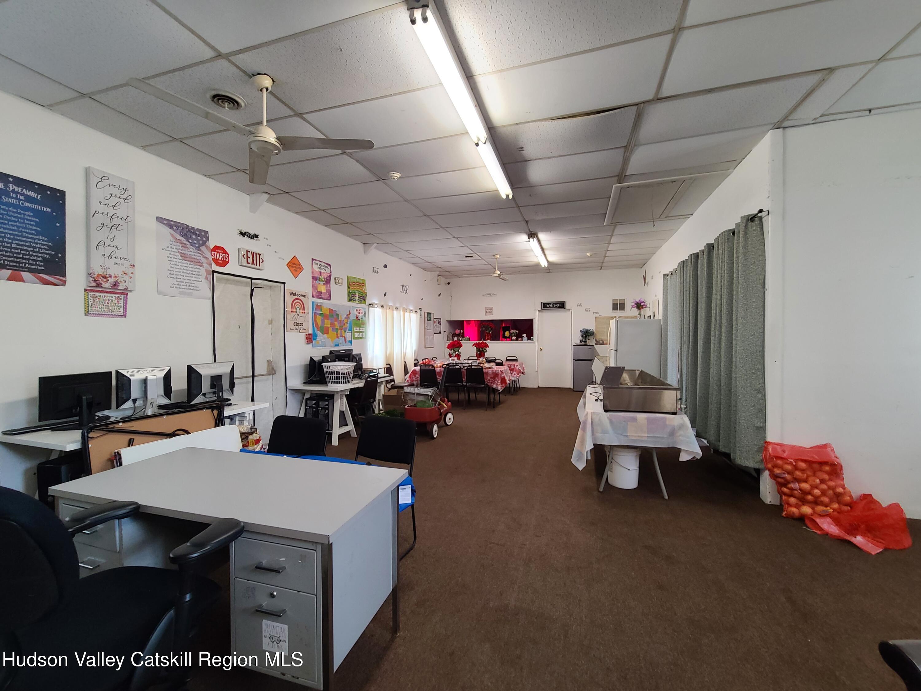 36 Cold Spring Road Monticello, NY 12701 - Photo 15 of 35 a living room with lots of furniture and a chandelier