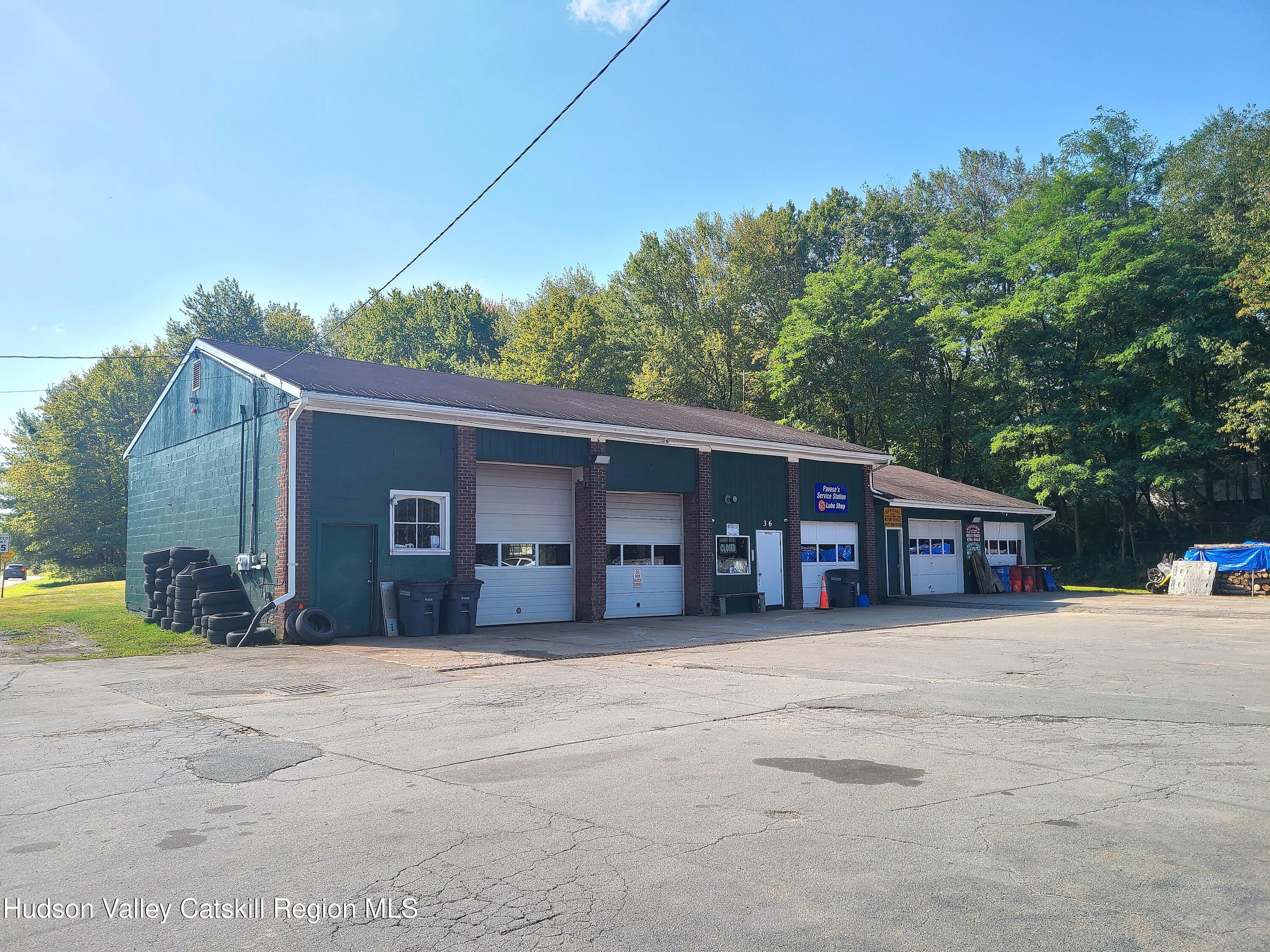 36 Cold Spring Road Monticello, NY 12701 - Photo 2 of 35 a front view of a house with a yard and garage