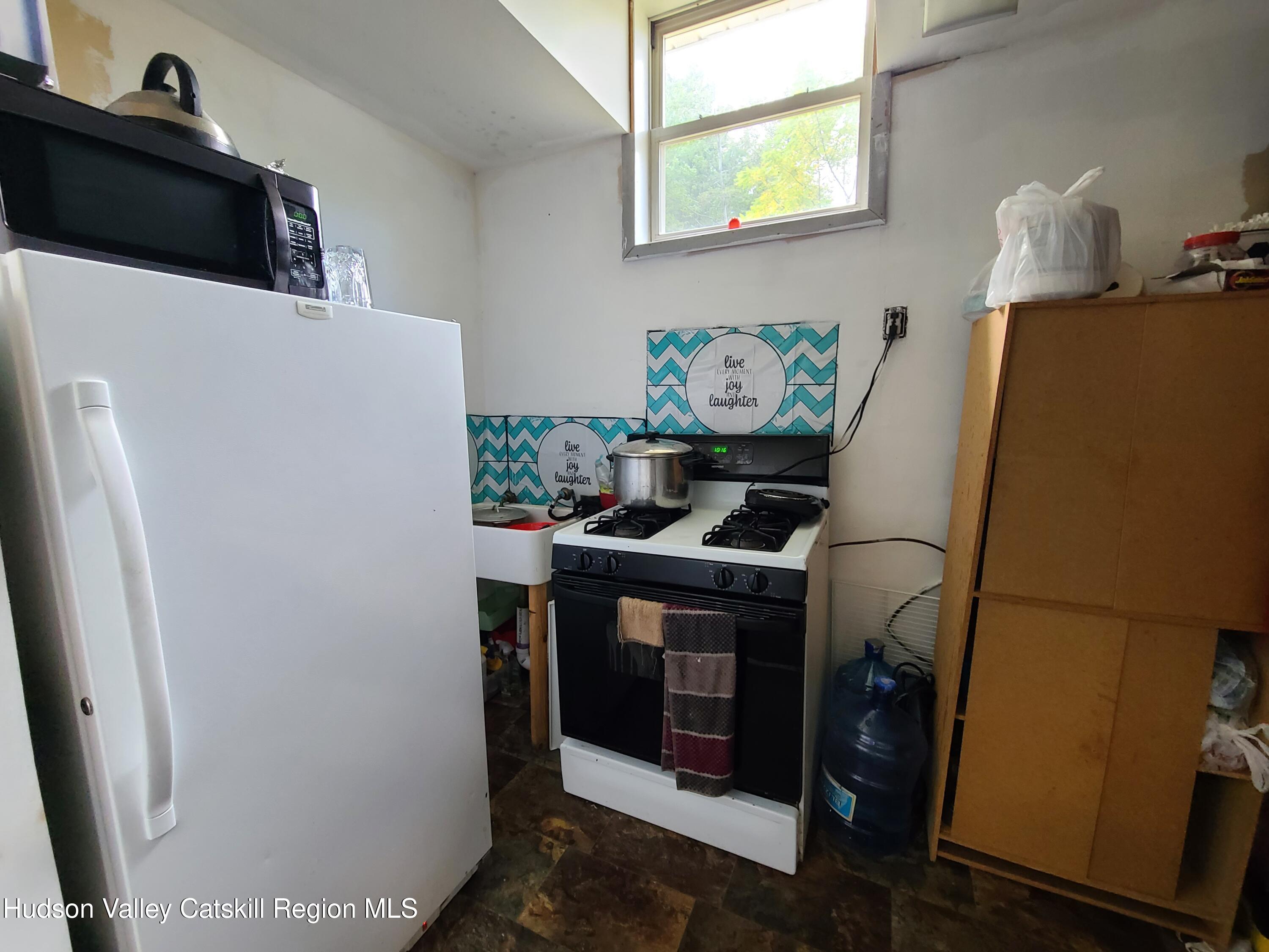 36 Cold Spring Road Monticello, NY 12701 - Photo 21 of 35 a white refrigerator freezer sitting inside of a kitchen